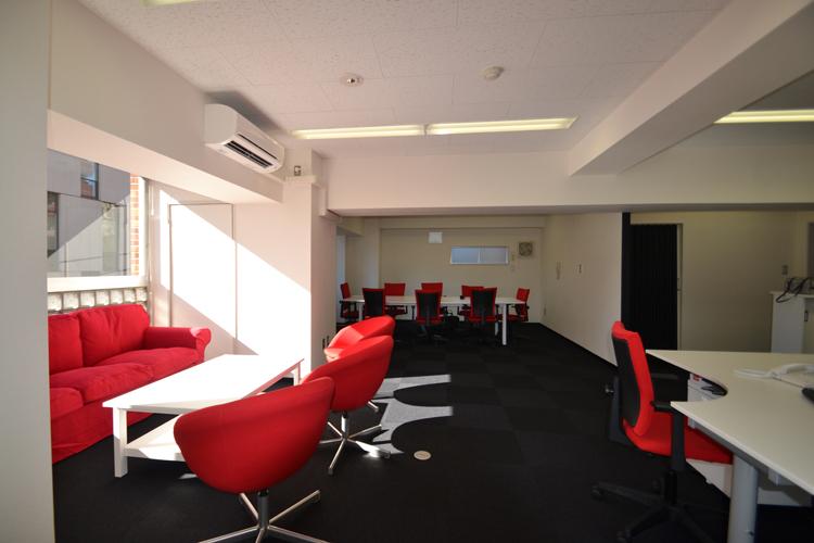 赤と黒を基調としてレイアウトした統一感のあるオフィス空間