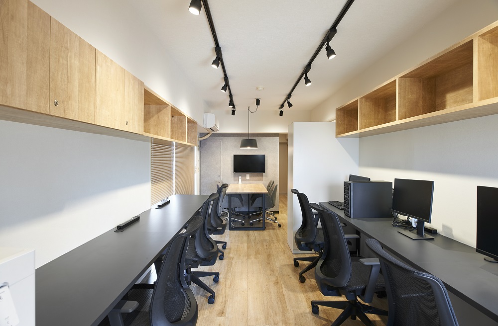木目の床とスポットライトの明るいオフィス空間